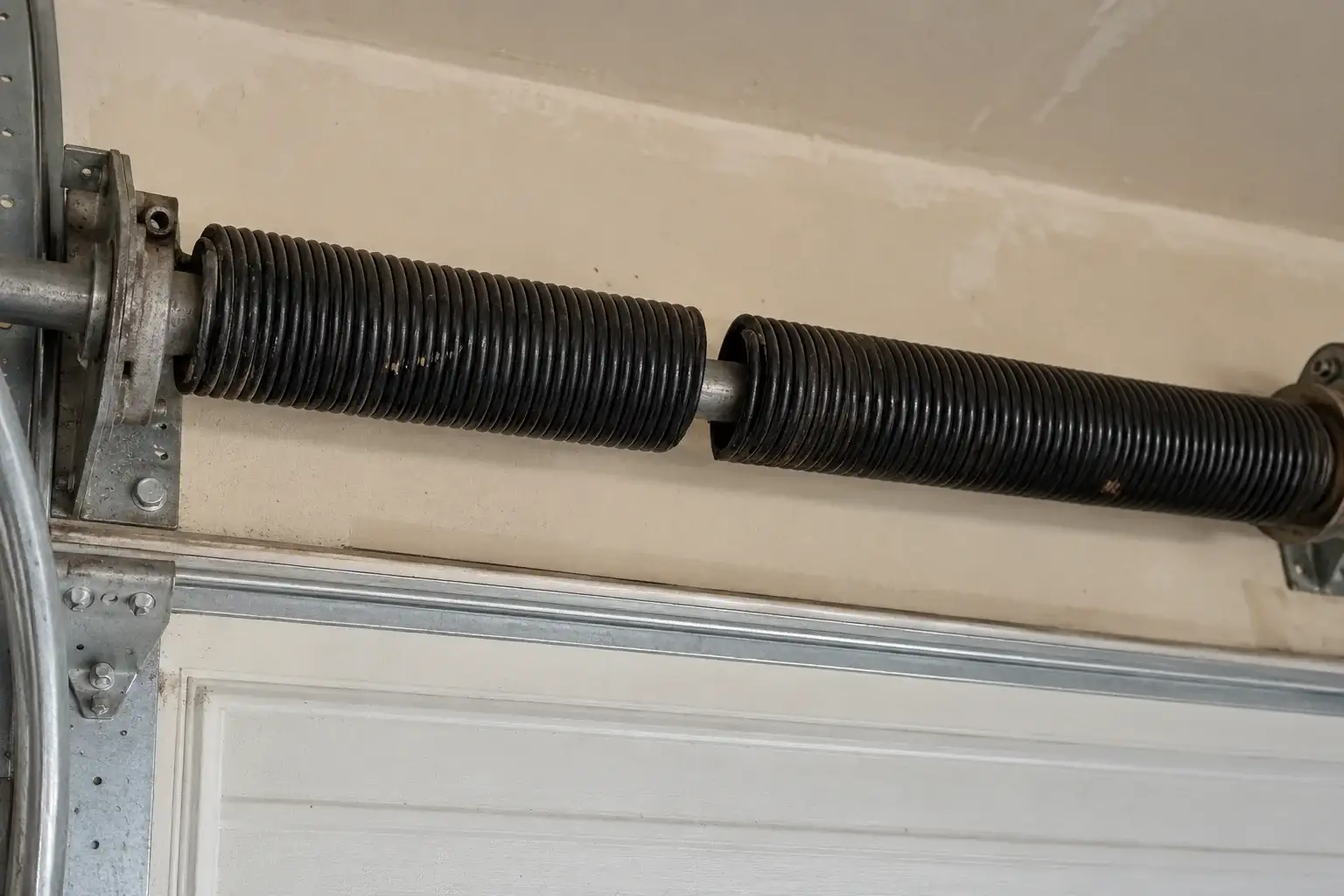 Torsion spring with a visible gap in the coil where it broke